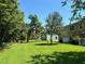 Large backyard featuring a well-maintained lawn, mature trees, and privacy at 11187 Savannah Landing Cir, Orlando, FL 32832