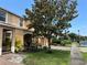 A row of townhomes featuring well-manicured lawns and lush trees along the street at 11187 Savannah Landing Cir, Orlando, FL 32832