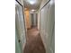 Hallway with neutral walls, carpet, recessed lighting and multiple white doors at 11187 Savannah Landing Cir, Orlando, FL 32832