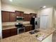 Updated kitchen with stainless steel appliances, granite countertops, breakfast bar, and warm wood cabinets at 11187 Savannah Landing Cir, Orlando, FL 32832