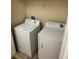 Laundry room with washer and dryer and overhead shelving at 11187 Savannah Landing Cir, Orlando, FL 32832