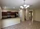 Bright living space includes tile floors, an elegant chandelier, and an open kitchen with stainless appliances at 11187 Savannah Landing Cir, Orlando, FL 32832