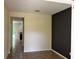 Living room displaying beige tiled floor, neutral paint, and a view into the kitchen area at 11187 Savannah Landing Cir, Orlando, FL 32832