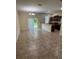 Spacious living and dining area with tiled floors, light fixture, and a view into the kitchen at 11187 Savannah Landing Cir, Orlando, FL 32832