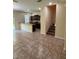 Open-concept living space features tile floors, kitchen with breakfast bar, and staircase to the second floor at 11187 Savannah Landing Cir, Orlando, FL 32832