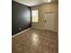 Living room featuring neutral paint and tile floors, with a window and door for natural light at 11187 Savannah Landing Cir, Orlando, FL 32832