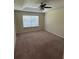 Main bedroom with a ceiling fan and a window for natural light at 11187 Savannah Landing Cir, Orlando, FL 32832