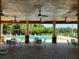 View of the community pool area, complete with shaded seating, ceiling fans, and comfortable lounge chairs at 11187 Savannah Landing Cir, Orlando, FL 32832