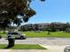 A street view of the townhome community featuring townhome units and green spaces on a sunny day at 11187 Savannah Landing Cir, Orlando, FL 32832