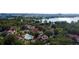 Aerial view of the community, tennis courts, pool, and red-roofed buildings surrounded by lush greenery at 11568 Westwood Blvd # 1015, Orlando, FL 32821