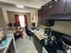 Kitchen with countertops, range, and ample cabinet space, connecting to dining at 11568 Westwood Blvd # 1015, Orlando, FL 32821