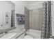 Clean bathroom featuring a tub, shower, granite countertop, and elegant fixtures at 1219 Normandy Dr, Haines City, FL 33844