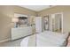 Bright bedroom features a large dresser with decor, neutral tones, and ensuite access at 1219 Normandy Dr, Haines City, FL 33844