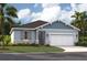 Charming single-story home with a two-car garage, beautiful stonework, and a well-manicured lawn at 1219 Normandy Dr, Haines City, FL 33844