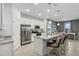 Bright, open kitchen with stainless steel appliances, granite countertops, and a breakfast bar at 1219 Normandy Dr, Haines City, FL 33844