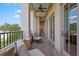 Covered balcony with stone flooring, comfortable lounge chairs, and ceiling fan at 140 E Morse Blvd # J, Winter Park, FL 32789