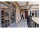 Lovely balcony with stone tile floors, dark wood front door, black railings, and beige exterior paint at 140 E Morse Blvd # J, Winter Park, FL 32789