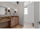 Elegant bathroom featuring a marble countertop, ornate mirrors, and decorative lighting fixtures at 140 E Morse Blvd # J, Winter Park, FL 32789