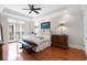 Serene main bedroom with hardwood floors, a comfortable bed, and French doors to the balcony offering abundant light at 140 E Morse Blvd # J, Winter Park, FL 32789