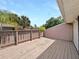 Outdoor wooden back deck features wood railing and space for entertaining guests at 1404 Oak Pl # A, Apopka, FL 32712