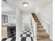 Inviting entryway with black and white floors, leading to kitchen, living room, and stairs at 1404 Oak Pl # A, Apopka, FL 32712