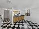 Bright kitchen features wood cabinets, dark countertops, and unique black-and-white checkered flooring at 1404 Oak Pl # A, Apopka, FL 32712