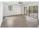 Spacious living room with wood-look flooring, natural light, and access to outdoor patio at 1404 Oak Pl # A, Apopka, FL 32712