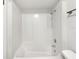 Clean, all-white shower and tub combo with updated fixtures and a built-in shower caddy at 1404 Oak Pl # A, Apopka, FL 32712