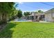 Lush backyard featuring a large pool, screened patio, lounge chairs, and privacy landscaping at 1770 Chinook Trl, Maitland, FL 32751
