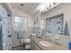 Bathroom features a granite countertop, grey tiling and a window for natural light at 1770 Chinook Trl, Maitland, FL 32751