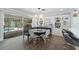 Cozy dining area with custom banquette seating, chandelier, and built-in shelving, next to a sliding door at 1770 Chinook Trl, Maitland, FL 32751