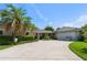 Charming single-story home with a circular driveway, mature landscaping, and an attached two-car garage at 1770 Chinook Trl, Maitland, FL 32751