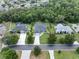 Aerial view of homes with lush landscaping, a nice street, and screened in pools at 1907 Sir Lancelot Cir, St Cloud, FL 34772