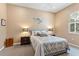 Comfortable bedroom features neutral colored walls, a queen sized bed, and dark wooden nightstands with stylish lamps at 1907 Sir Lancelot Cir, St Cloud, FL 34772