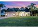 Inviting home featuring a lush lawn, well-manicured landscaping, and a side-entry two-car garage at 1907 Sir Lancelot Cir, St Cloud, FL 34772
