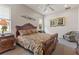Spacious bedroom featuring a decorative headboard bed, matching dressers, and a sitting chair with floral design at 1907 Sir Lancelot Cir, St Cloud, FL 34772