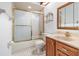 Bathroom boasts a tub and shower combo, vanity with sink, and ample lighting at 2003 Bentwood Dr, Winter Park, FL 32792