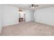Bright bedroom with neutral carpeting, ceiling fan, and adjacent vanity area at 2003 Bentwood Dr, Winter Park, FL 32792