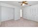 Bright bedroom features a double closet for extra storage, neutral carpet, and a ceiling fan at 2003 Bentwood Dr, Winter Park, FL 32792