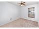 Bedroom features a window with wooden blinds, neutral carpet, and a ceiling fan at 2003 Bentwood Dr, Winter Park, FL 32792