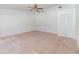 Spacious bedroom featuring plush carpeting, a ceiling fan, and a convenient closet at 2003 Bentwood Dr, Winter Park, FL 32792