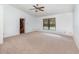 Bright bedroom features a ceiling fan, neutral carpet, and a window for natural light at 2003 Bentwood Dr, Winter Park, FL 32792