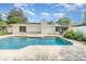 Inviting pool with backyard surrounded by mature trees, with white fence at 2003 Bentwood Dr, Winter Park, FL 32792