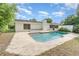 Inviting pool with backyard surrounded by mature trees, with white fence at 2003 Bentwood Dr, Winter Park, FL 32792
