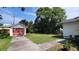 Spacious backyard featuring a detached garage, mature trees and plenty of room for outdoor activities at 206 N Highland Ave, Winter Garden, FL 34787