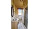 Cozy bath with sink, toilet, shower, window, textured wallpaper, and tiled flooring at 206 N Highland Ave, Winter Garden, FL 34787