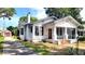 Charming white two-story house featuring a screened-in porch, chimney and mature landscaping at 206 N Highland Ave, Winter Garden, FL 34787