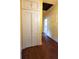 Bright hallway features hardwood floors, yellow walls, and convenient storage at 206 N Highland Ave, Winter Garden, FL 34787