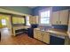 Nostalgic kitchen features retro cabinets, appliances, a functional layout, and laminate flooring at 206 N Highland Ave, Winter Garden, FL 34787