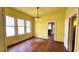 Bright living room featuring hardwood floors, ornate chandelier, and multiple windows offering plenty of natural light at 206 N Highland Ave, Winter Garden, FL 34787